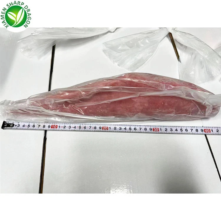 Tuna loin size and trim Wrapped red tuna loin beside a measuring tape